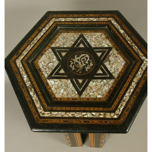 554 - A SYRIAN MOTHER OF PEARL INLAID EBONISED OCCASIONAL TABLE, the hexagonal top with star within a fram... 