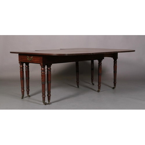 556 - A REGENCY MAHOGANY EXTENDING DINING TABLE, rectangular with rounded end panels, the frieze inlaid wi... 