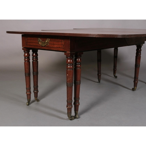 556 - A REGENCY MAHOGANY EXTENDING DINING TABLE, rectangular with rounded end panels, the frieze inlaid wi... 