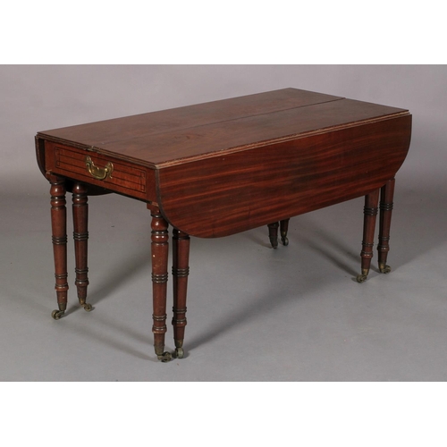 556 - A REGENCY MAHOGANY EXTENDING DINING TABLE, rectangular with rounded end panels, the frieze inlaid wi... 