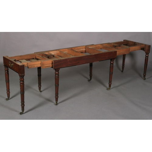 556 - A REGENCY MAHOGANY EXTENDING DINING TABLE, rectangular with rounded end panels, the frieze inlaid wi... 