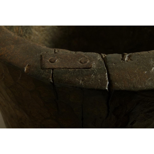 558 - AN 18TH CENTURY TWO HANDLED WOODEN MORTAR of chip-carved cylindrical trunk form with angular handles... 