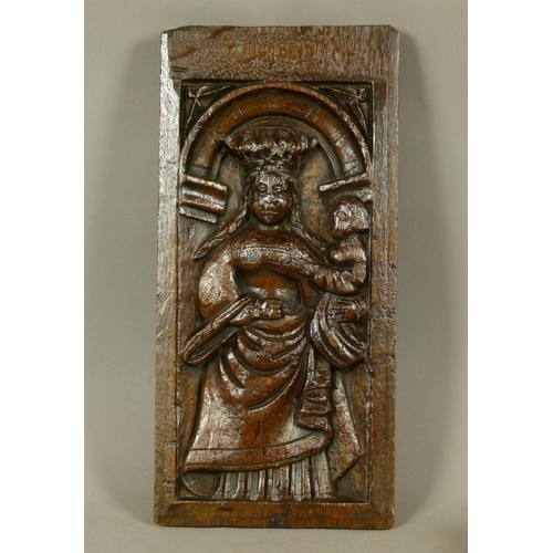 562 - A 16TH CENTURY OAK FIGURAL PANEL the arched frame carved with a crowned female holding an infant, 38... 