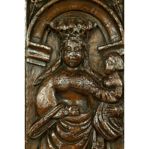 562 - A 16TH CENTURY OAK FIGURAL PANEL the arched frame carved with a crowned female holding an infant, 38... 