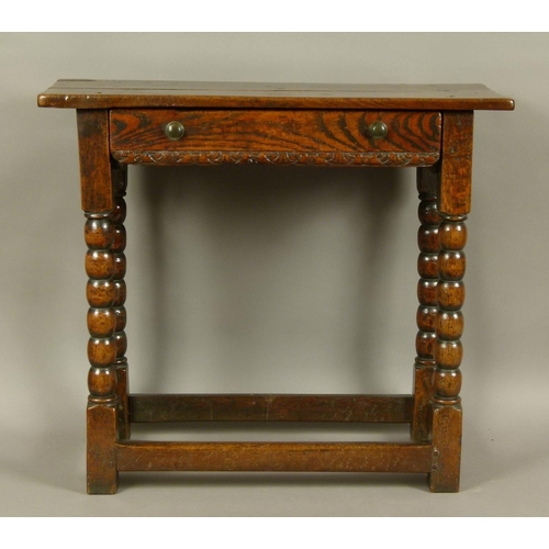 576 - A 17TH CENTURY OAK SINGLE DRAWER SIDE TABLE, the twin plank top above a figured drawer with foliate ... 