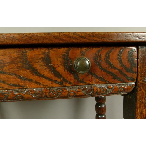 576 - A 17TH CENTURY OAK SINGLE DRAWER SIDE TABLE, the twin plank top above a figured drawer with foliate ... 