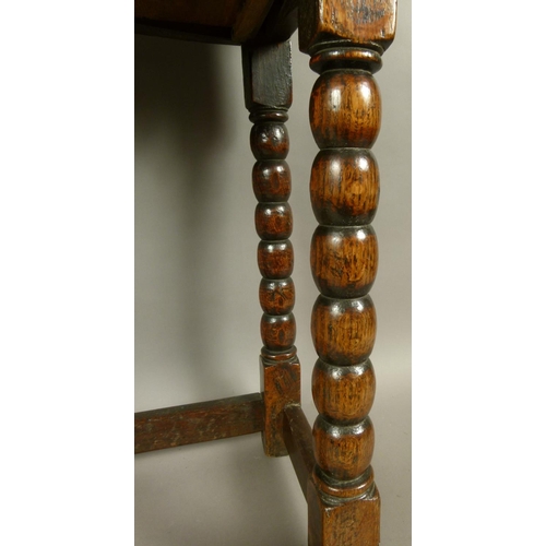 576 - A 17TH CENTURY OAK SINGLE DRAWER SIDE TABLE, the twin plank top above a figured drawer with foliate ... 