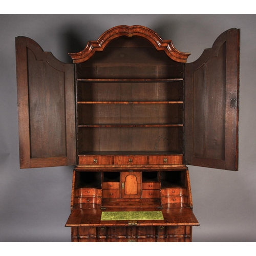 578 - A MID-TO LATE 18TH CENTURY WALNUT VENEERED BUREAU BOOKCASE, the arched top with cavetto moulded corn... 