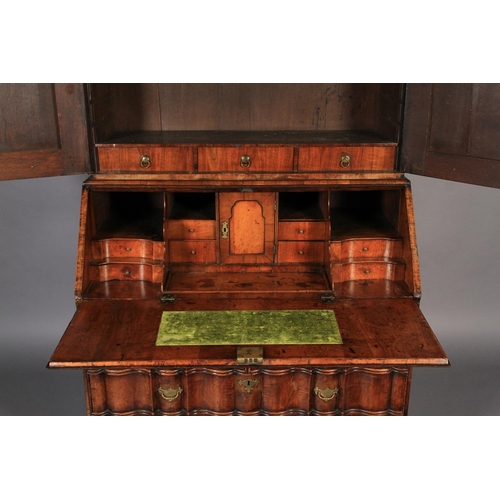 578 - A MID-TO LATE 18TH CENTURY WALNUT VENEERED BUREAU BOOKCASE, the arched top with cavetto moulded corn... 