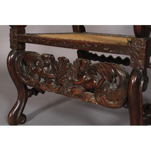 584 - A FLEMISH WALNUT ARMCHAIR 17TH CENTURY AND LATER, having a pierced cresting carved with foliate crow... 