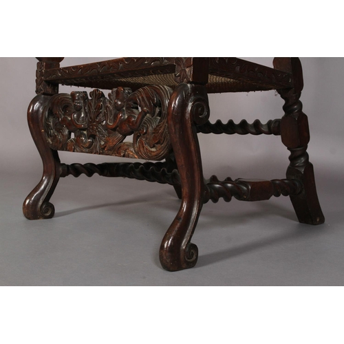 584 - A FLEMISH WALNUT ARMCHAIR 17TH CENTURY AND LATER, having a pierced cresting carved with foliate crow... 