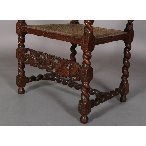 587 - A CHARLES II STYLE WALNUT ARMCHAIR 19TH CENTURY, having a pierced cresting carved with pair of birds... 