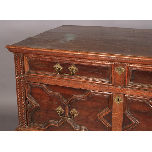 590 - A CHARLES II OAK AND CEDARWOOD CHEST, having a moulded top above alternating shallow and deep drawer... 