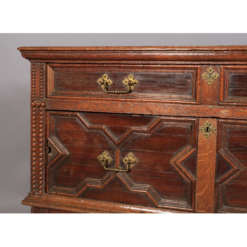 590 - A CHARLES II OAK AND CEDARWOOD CHEST, having a moulded top above alternating shallow and deep drawer... 