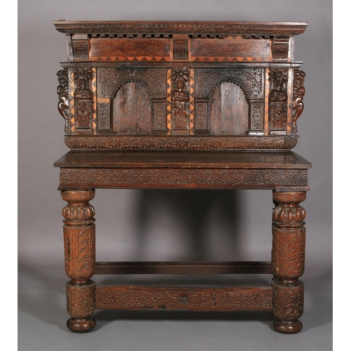 591 - AN OAK SERVING TABLE in 17th century style, the projecting canopy above a deep frieze with applied d... 