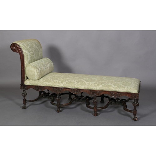 593 - A 19TH CENTURY OAK DAY BED IN CAROLEAN STYLE, high foliate carved and moulded frame upholstered in p... 