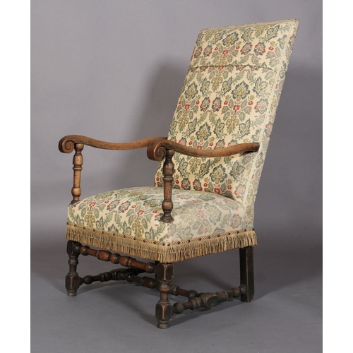 595 - A FLEMISH WALNUT ARMCHAIR, late 17th century, the later upholstered back and seat with scrolled arms... 