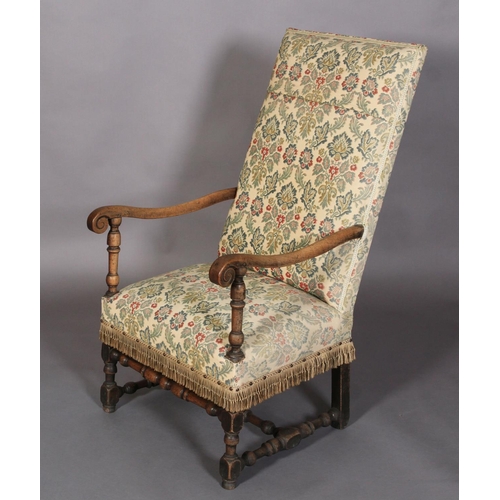 595 - A FLEMISH WALNUT ARMCHAIR, late 17th century, the later upholstered back and seat with scrolled arms... 