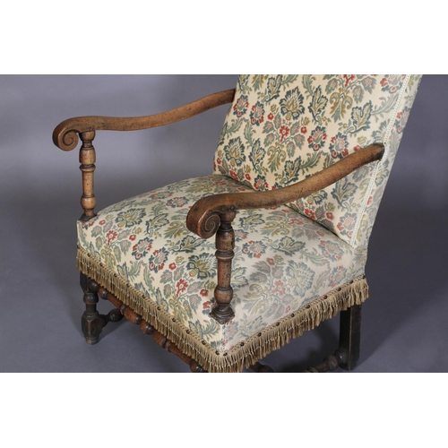 595 - A FLEMISH WALNUT ARMCHAIR, late 17th century, the later upholstered back and seat with scrolled arms... 