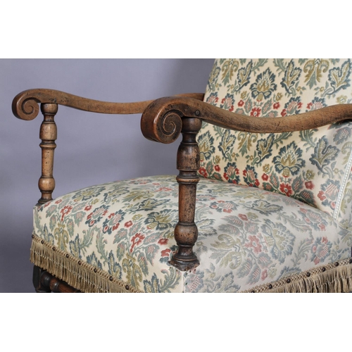 595 - A FLEMISH WALNUT ARMCHAIR, late 17th century, the later upholstered back and seat with scrolled arms... 