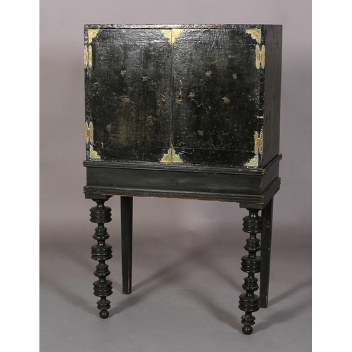 596 - A 17TH CENTURY BLACK LACQUER CABINET ON STAND, the pair of doors highlighted with sprigs of oak leav... 