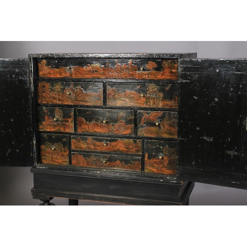 596 - A 17TH CENTURY BLACK LACQUER CABINET ON STAND, the pair of doors highlighted with sprigs of oak leav... 