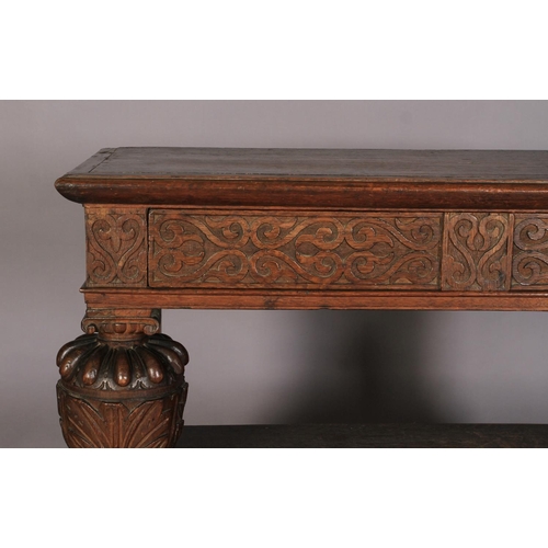 601 - AN OAK THREE TIER BUFFET in mid 16th century style, the top above foliate carved frieze drawer, the ... 