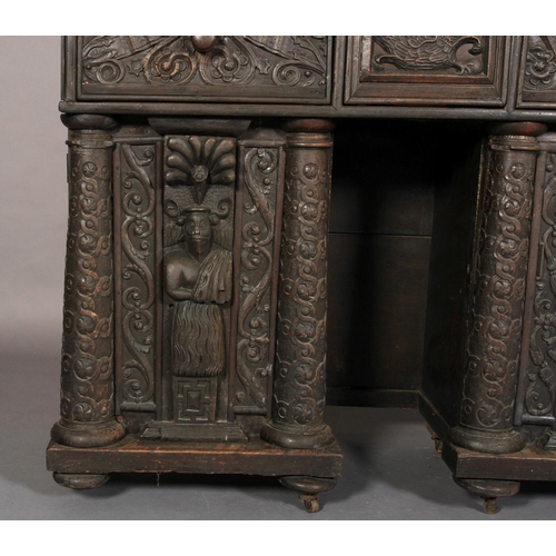 602 - AN OAK DRESSER/CUPBOARD in 16th century style, dentil moulded cornice above a frieze centred on a gr... 