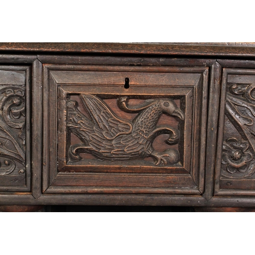 602 - AN OAK DRESSER/CUPBOARD in 16th century style, dentil moulded cornice above a frieze centred on a gr... 