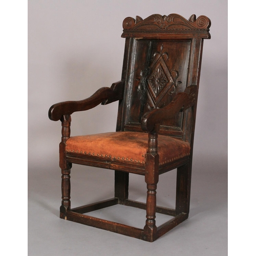 609 - AN OAK ARMCHAIR in 17th century style, the carved top rail above a lozenge carved panel back, slab a... 