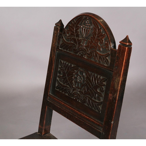 610 - AN OAK DERBYSHIRE CHAIR 19th century the arched panel back carved with stylised flower heads and lea... 