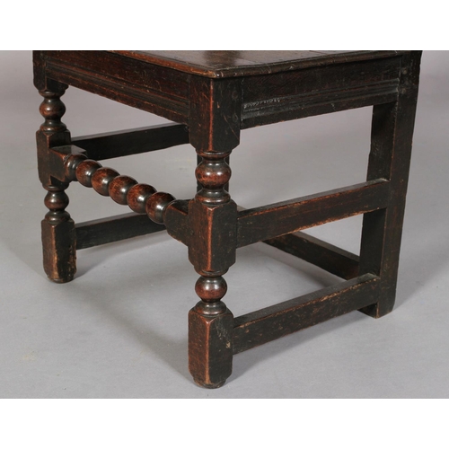 610 - AN OAK DERBYSHIRE CHAIR 19th century the arched panel back carved with stylised flower heads and lea... 