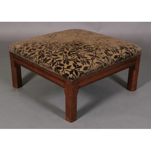 613 - AN OAK SQUARE FOOT STOOL with moulded frame and chamfered square legs, the stuffed over top upholste... 