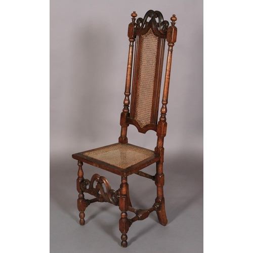 614 - A WILLIAM AND MARY WALNUT AND BEECH HIGH BACK CHAIR with pierced scroll carved cresting rail above a... 