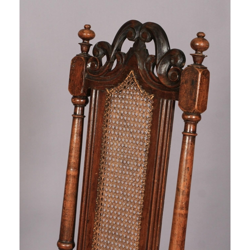 614 - A WILLIAM AND MARY WALNUT AND BEECH HIGH BACK CHAIR with pierced scroll carved cresting rail above a... 