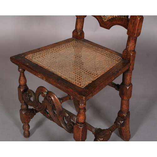 614 - A WILLIAM AND MARY WALNUT AND BEECH HIGH BACK CHAIR with pierced scroll carved cresting rail above a... 