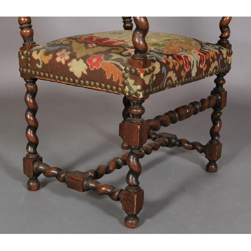 615 - A VICTORIAN OAK ELBOW CHAIR in late 17th century style, the barley twist turned arms terminating in ... 