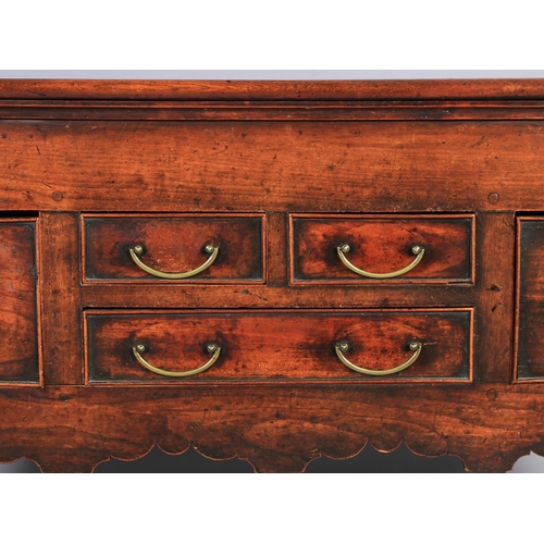 616 - AN EARLY 19TH CENTURY FRUITWOOD DRESSER BASE, having a bead rail to the surface above two short and ... 