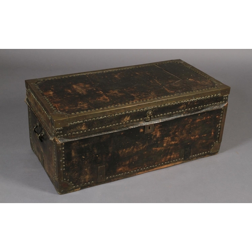 618 - A 19TH CENTURY LEATHER CLOSE NAILED AND BRASS BOUND TRUNK with side carrying handles, 93cm wide x 46... 