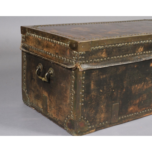 618 - A 19TH CENTURY LEATHER CLOSE NAILED AND BRASS BOUND TRUNK with side carrying handles, 93cm wide x 46... 