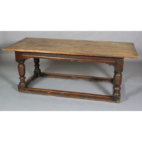 621 - A LATE 17TH CENTURY OAK REFECTORY TABLE, having a planked surface with cleat ends, moulded apron wit... 