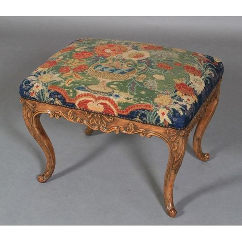 622 - A REGENCY STYLE STOOL IN WALNUT AND BEECH, rectangular, having a needlework upholstered seat, shell ... 