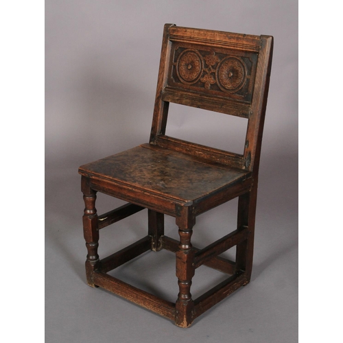 625 - AN 18TH CENTURY OAK SINGLE CHAIR , the panelled back carved with roundels and leafage, boarded seat,... 