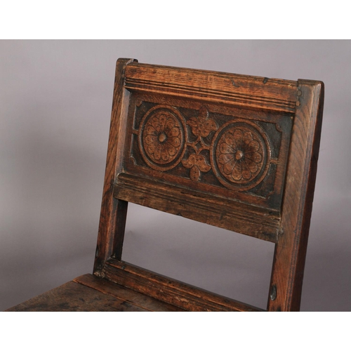 625 - AN 18TH CENTURY OAK SINGLE CHAIR , the panelled back carved with roundels and leafage, boarded seat,... 