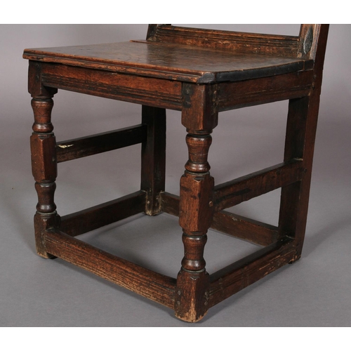 625 - AN 18TH CENTURY OAK SINGLE CHAIR , the panelled back carved with roundels and leafage, boarded seat,... 