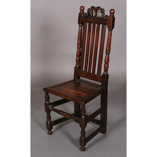 626 - A LATE 17TH CENTURY OAK SINGLE CHAIR c.1690 having a pierced and scrolled cresting above a slate bac... 