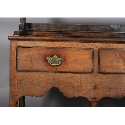 628 - A 19TH CENTURY DRESSER AND RACK, having a moulded cornice above a scalloped frieze, the open back wi... 