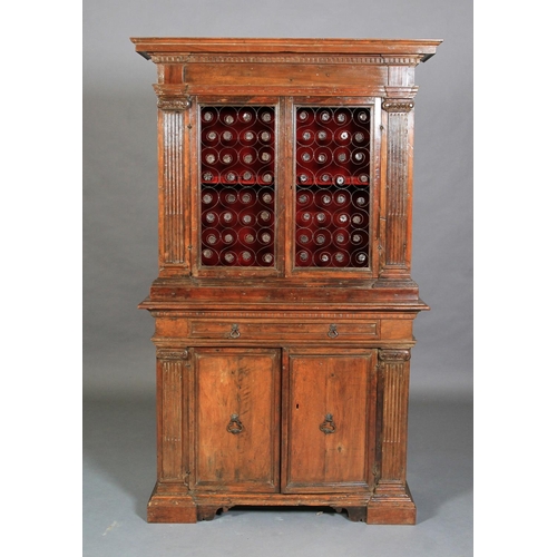 632 - AN ITALIAN WALNUT CUPBOARD, having a flared and dentil cornice above a deep frieze and two iron gril... 