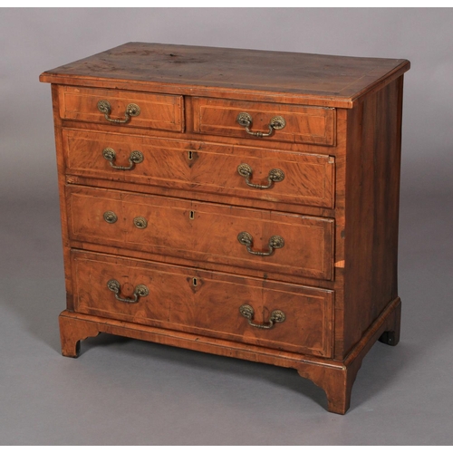 634 - A GEORGE III WALNUT DWARF CHEST OF DRAWERS crossbanded and inlaid in boxwood and ebony stringing, th... 