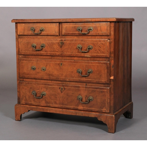 634 - A GEORGE III WALNUT DWARF CHEST OF DRAWERS crossbanded and inlaid in boxwood and ebony stringing, th... 